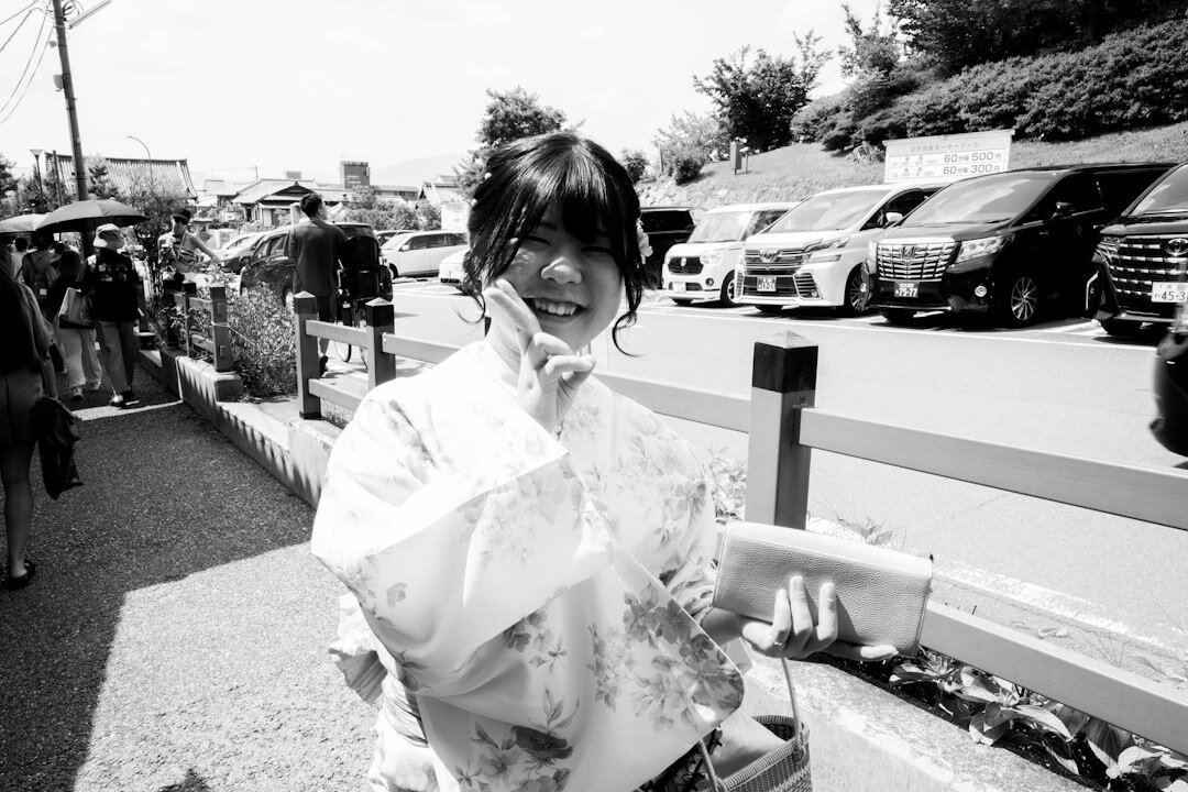 Japanese woman journalist smiling and holding a notebook